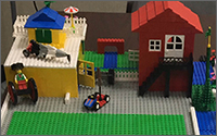 Two houses made of legos.