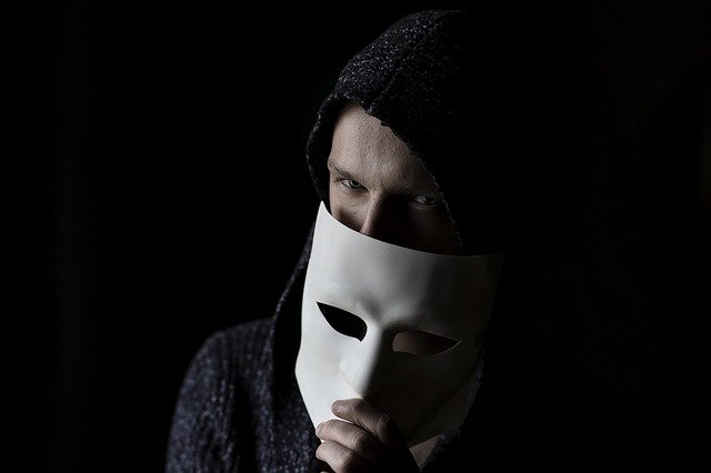 Man hiding behind a mask