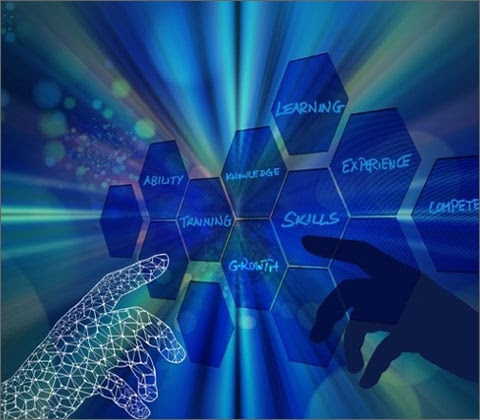 A hand choosing between blue hexagons, that are suspended in the air as if on a computer screen, with names like 'Skills,' 'Competence,' 'Learning,' and 'Experience.'